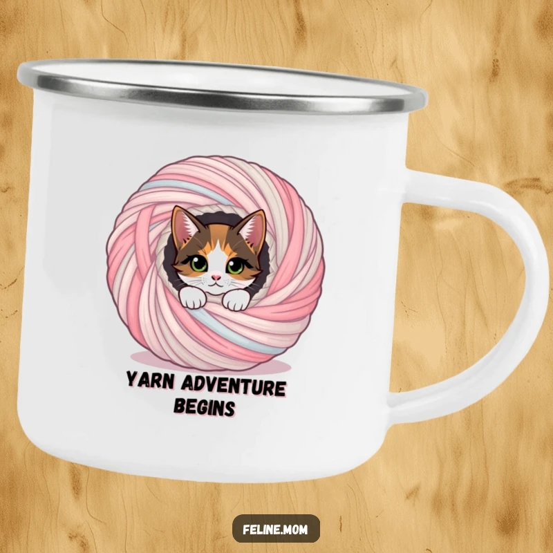 Funny calico cat peeking from a yarn ball, a sturdy and funny gift for outdoor enthusiasts.