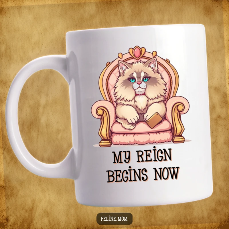 Funny Maine Coon mug featuring an elegant fluffy cat lounging like royalty on a plush, golden throne, looking incredibly pleased with itself.