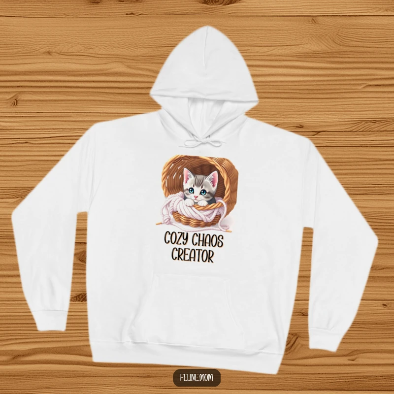Funny Curious Kitten Knitting Hoodie: A cute kitten peeks from a cozy knitting basket, offering warmth and adorable charm.