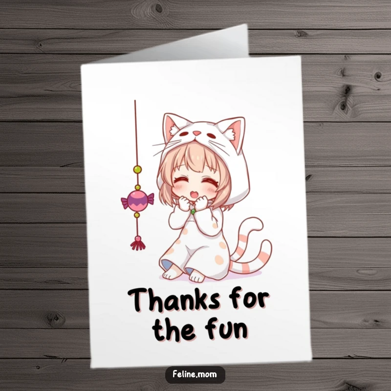 Funny free printable thank you card: woman dressed as a cat, playfully batting at a dangling toy to express thanks.